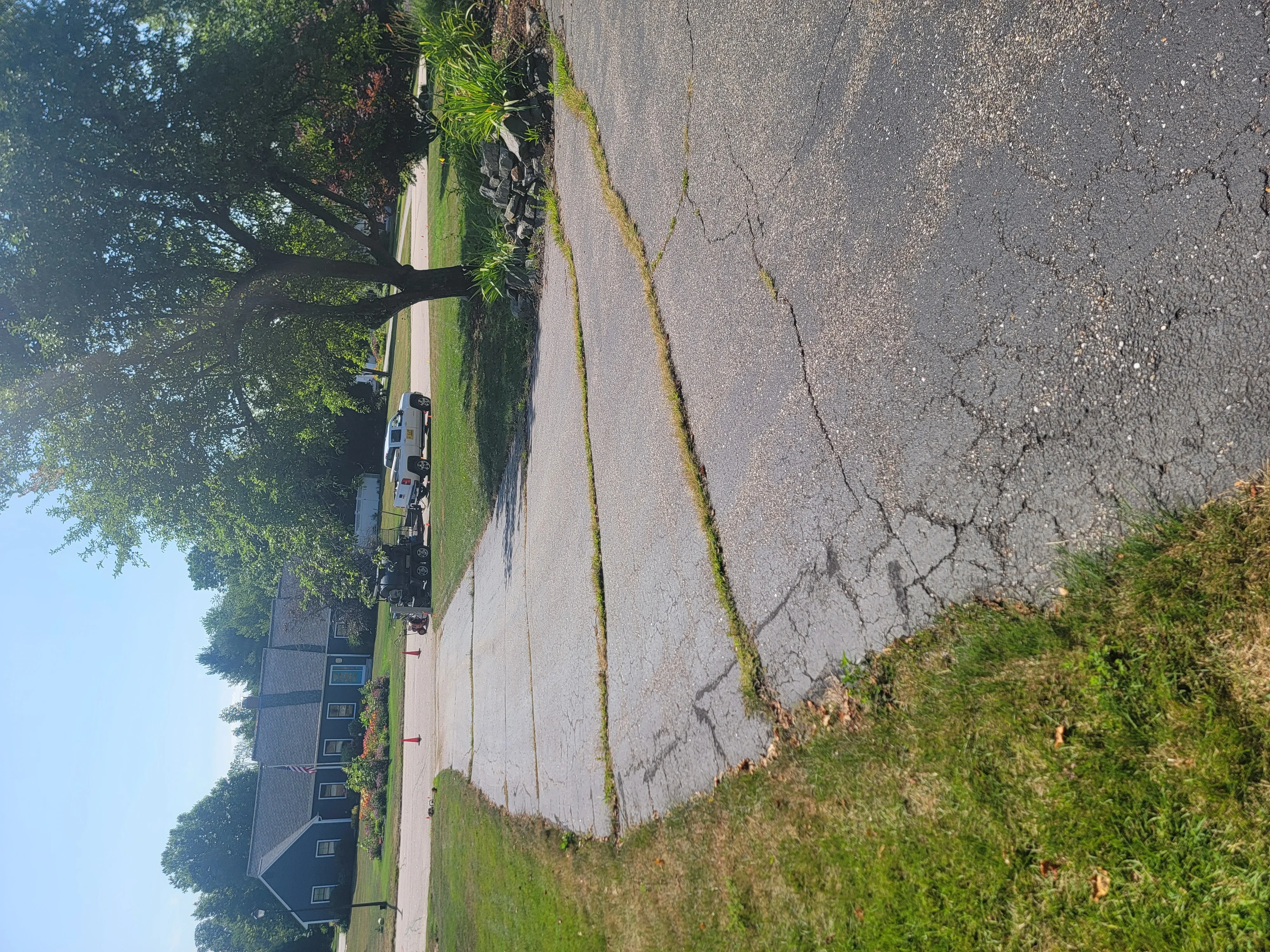 Residential asphalt driveway with sealcoating and crack repair work